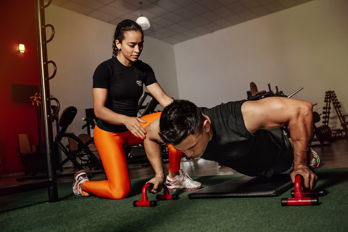 Personal trainer coaching a member in a premium gym